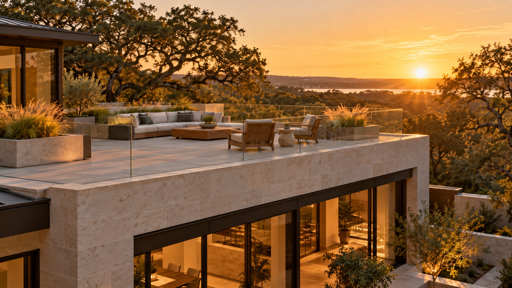 Rooftop deck with porcelain pavers, planters and glass railing at golden hour