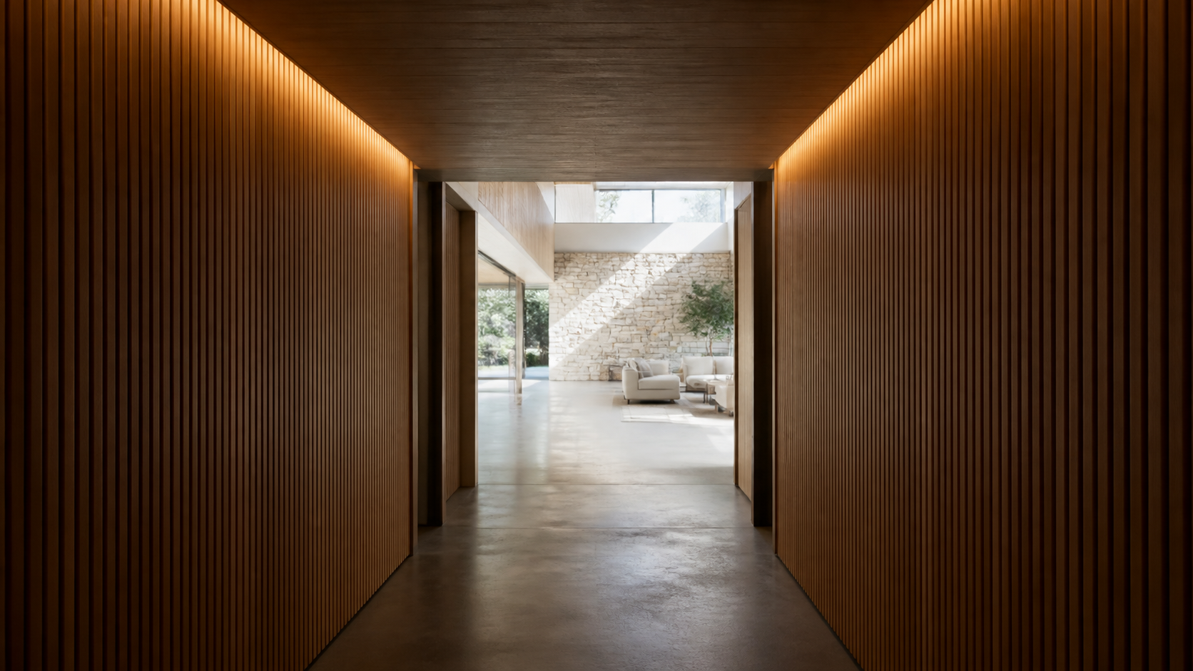 Low compressed hallway opening into a tall bright living space