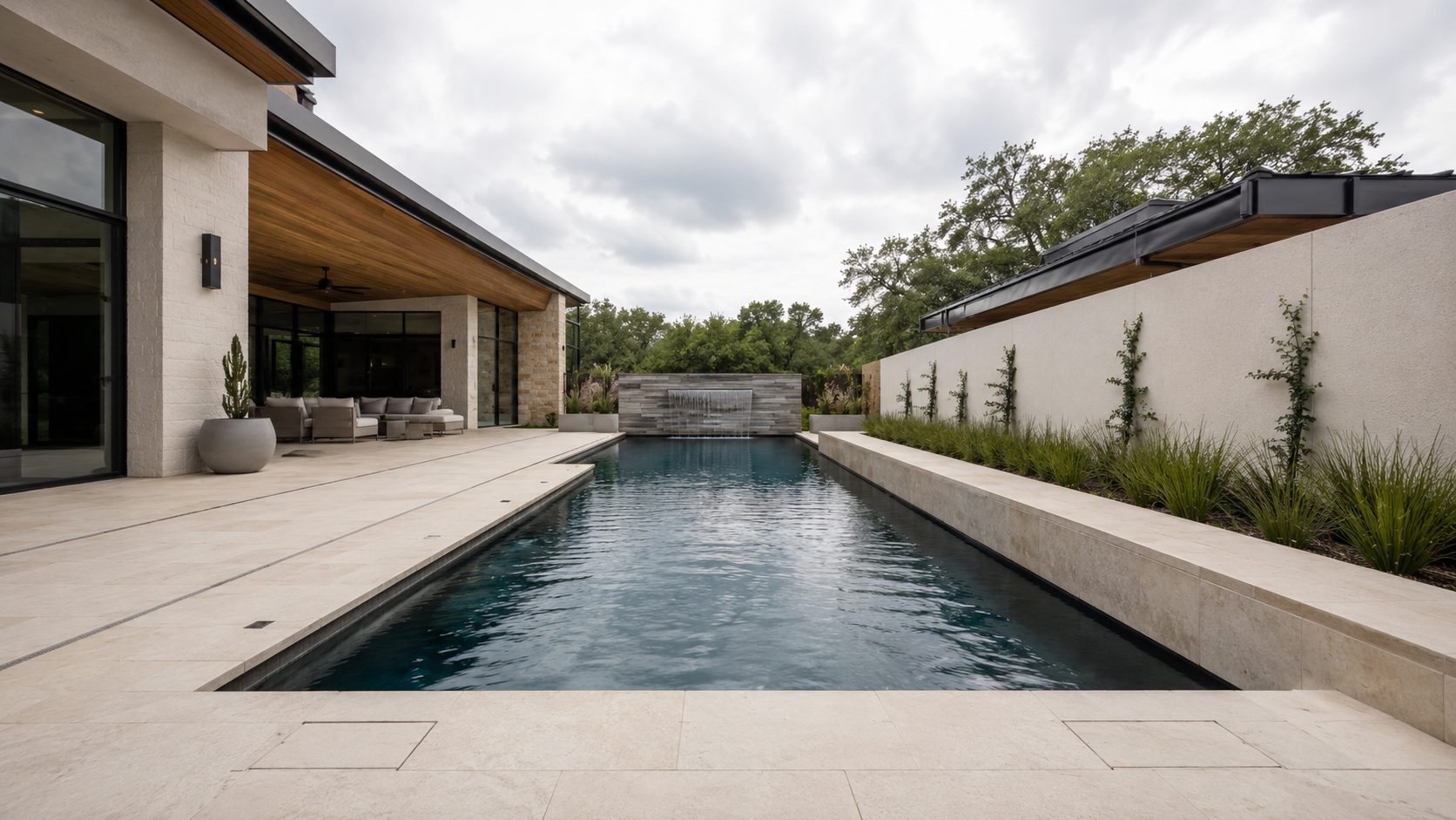 Rectangular pool bounded by a raised spa wall and low limestone bench