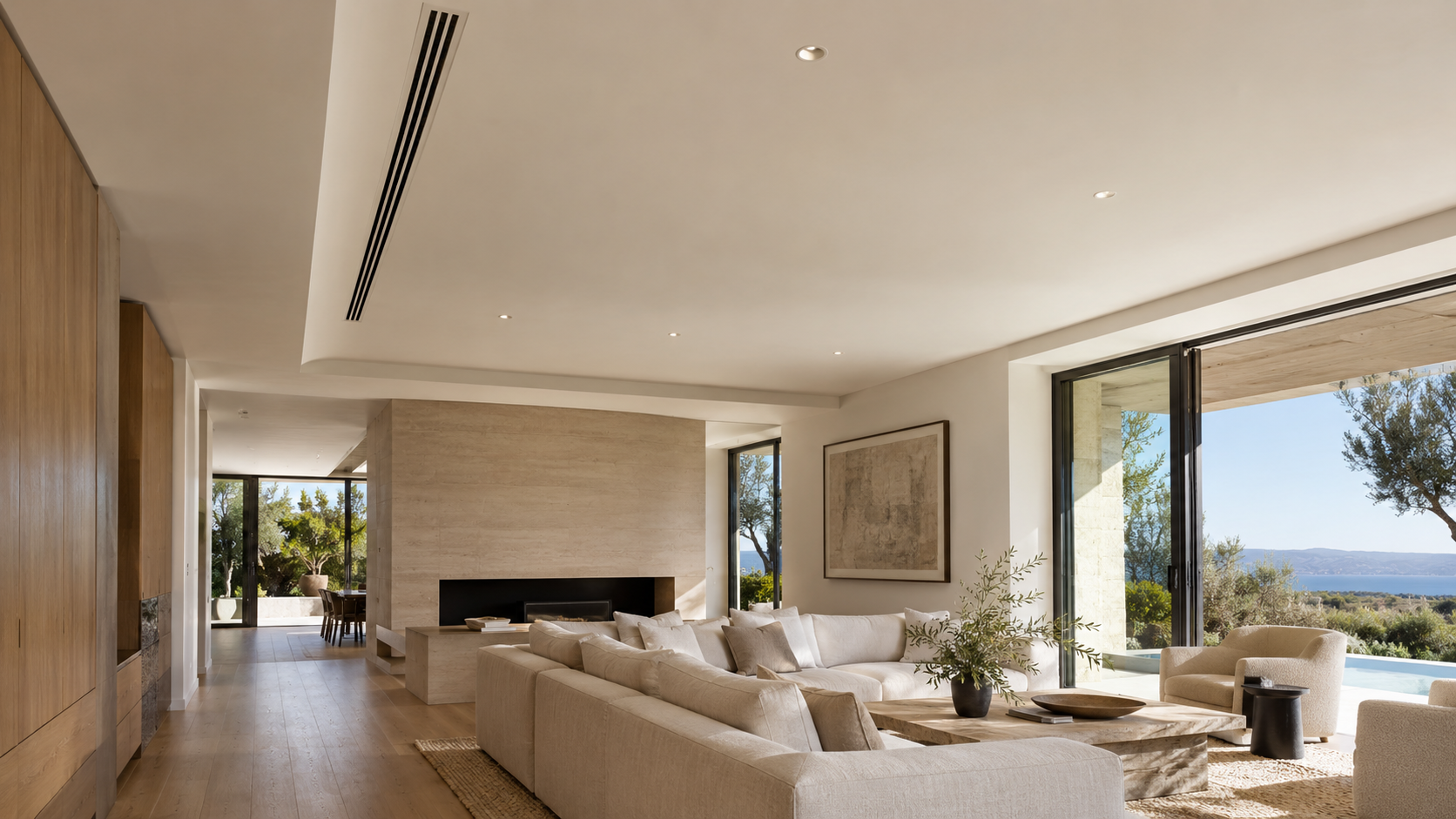 Flush linear slot air diffuser in a smooth plaster ceiling of a modern living room
