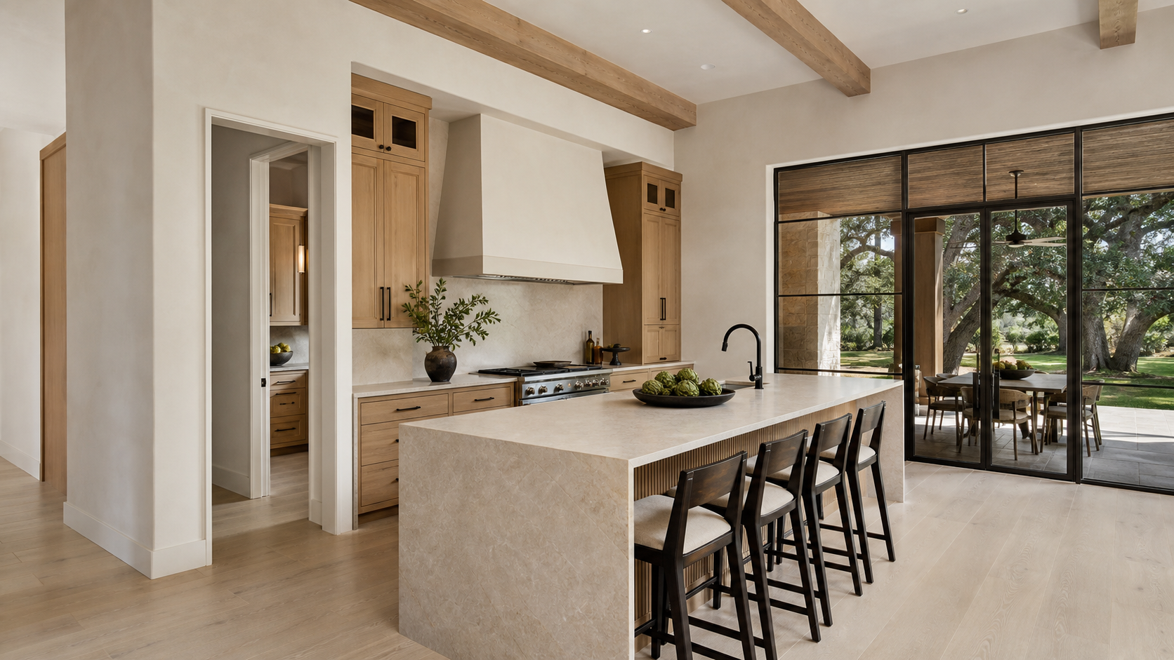Open luxury kitchen with an offset doorway partially concealing the scullery behind it