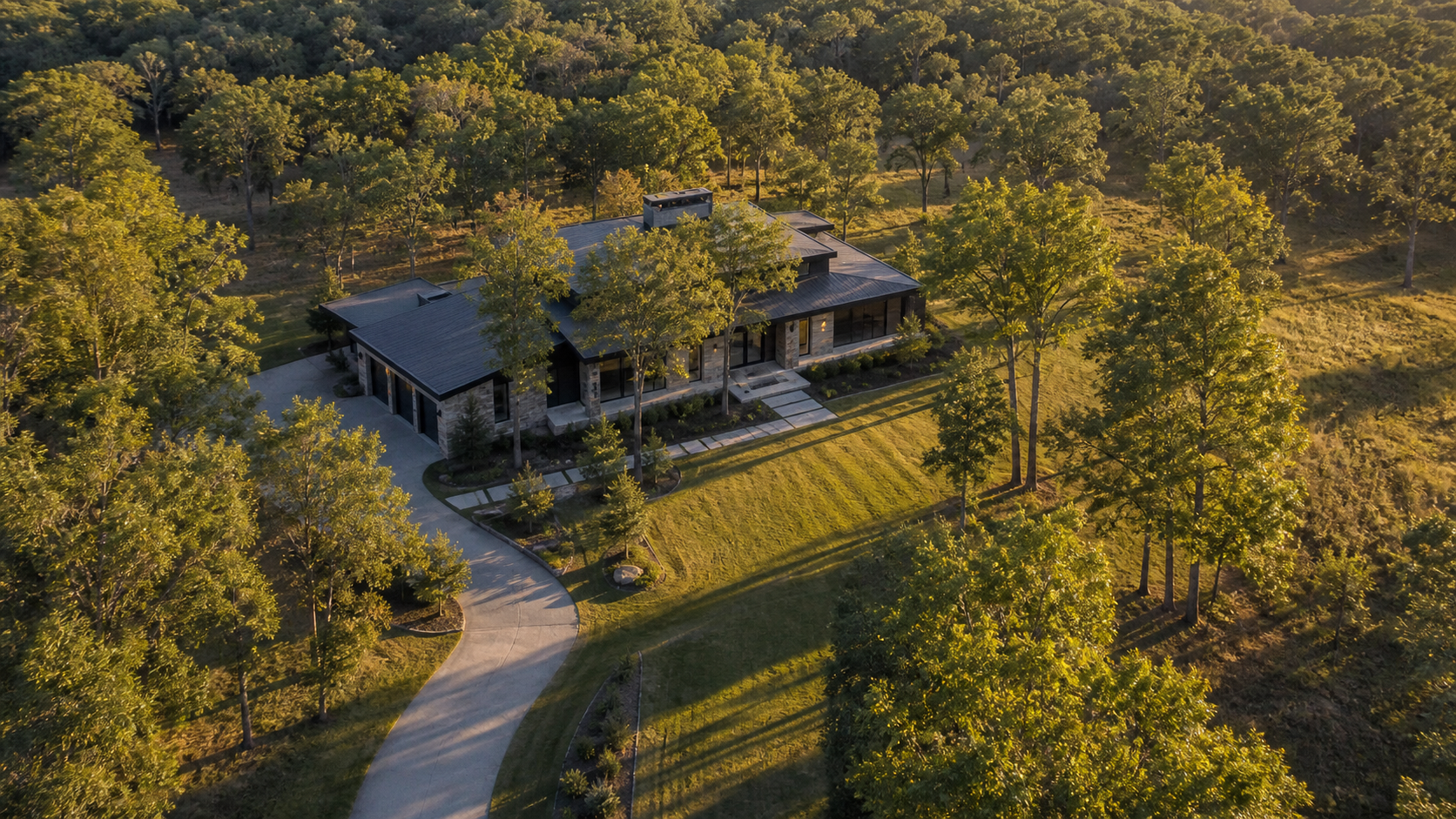 Aerial view of a modern home sited off-axis among mature trees on a wooded lot