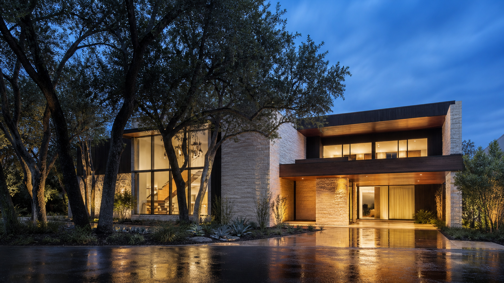 Dusk exterior of a modern custom home with laminated glass windows and mature trees screening the street