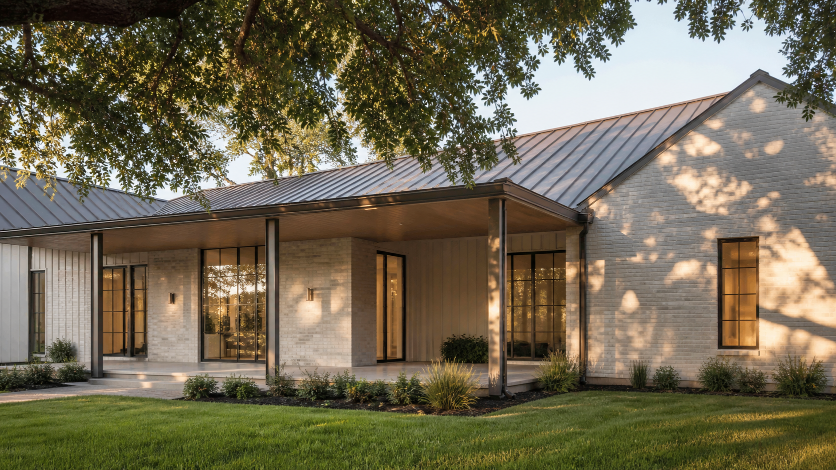 Limewashed white brick facade of a modern Texas custom home with a deep covered porch